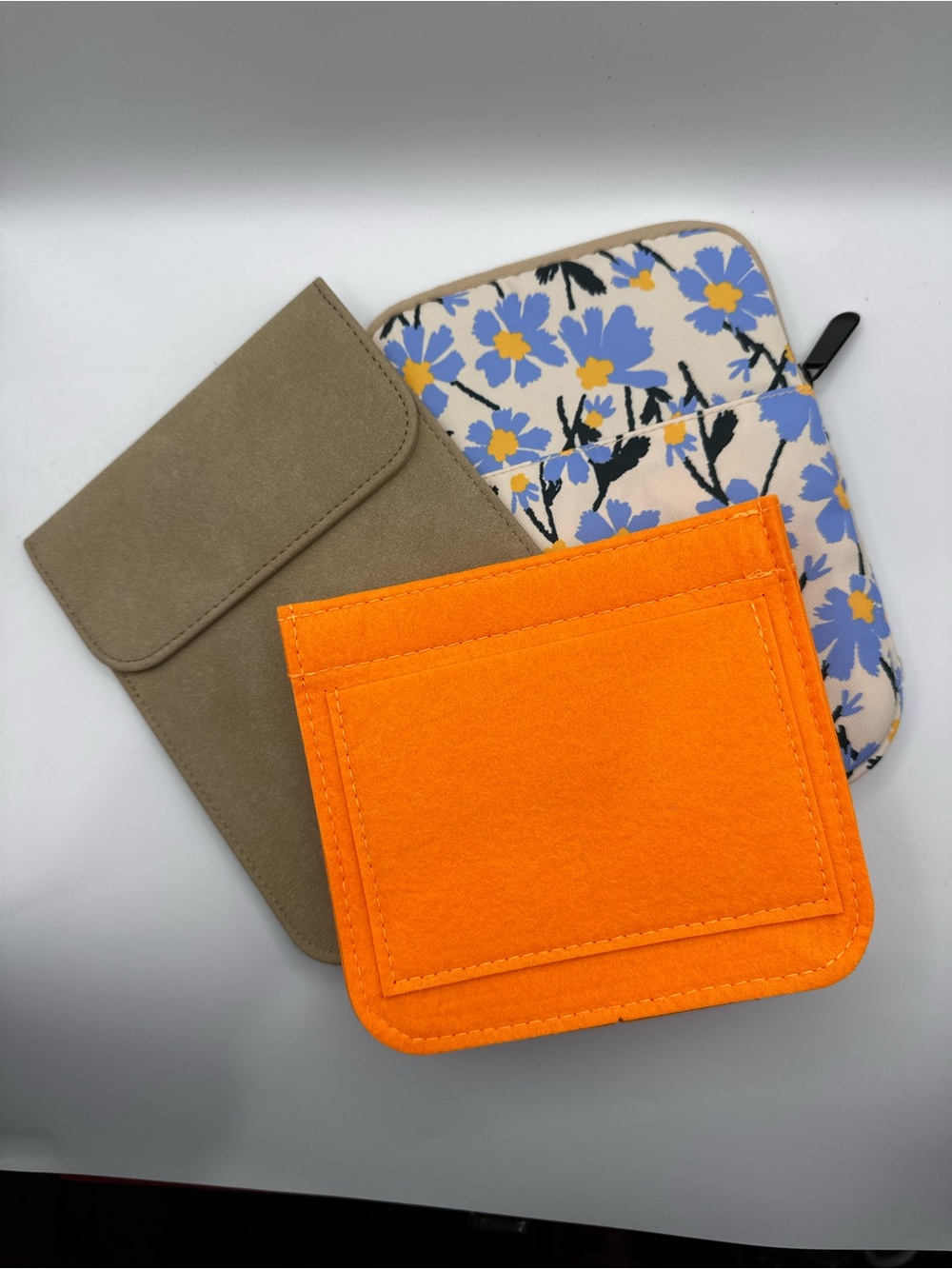 Bright Orange Felt Bag organizer with Floral Padded Bag and Suede Taupe pouch.
